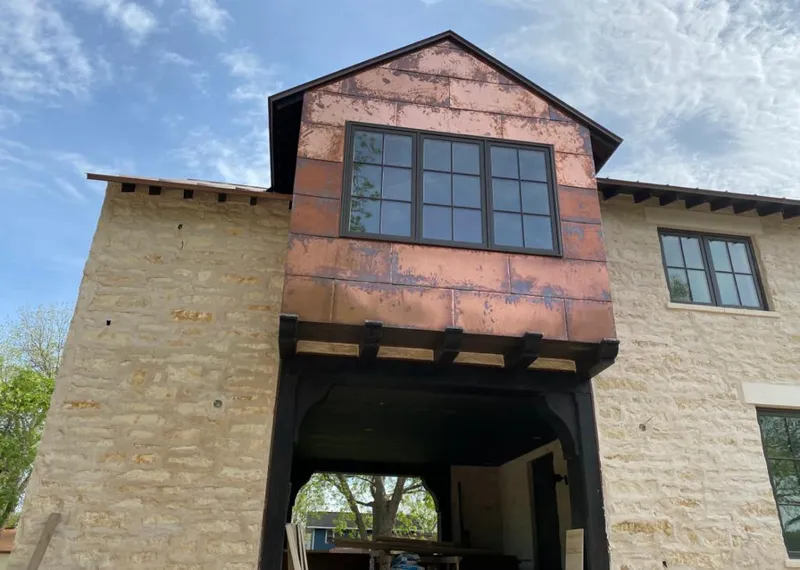 Copper metal panel facade on a stone building for Roof Repair in Painesville