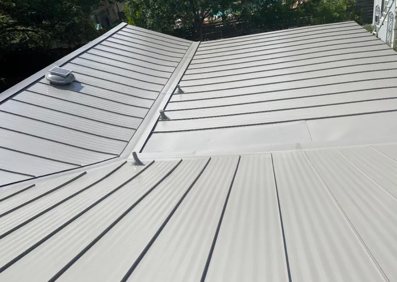 Solar attic fan installed on a metal roof for Roof Ventilation in Painesville